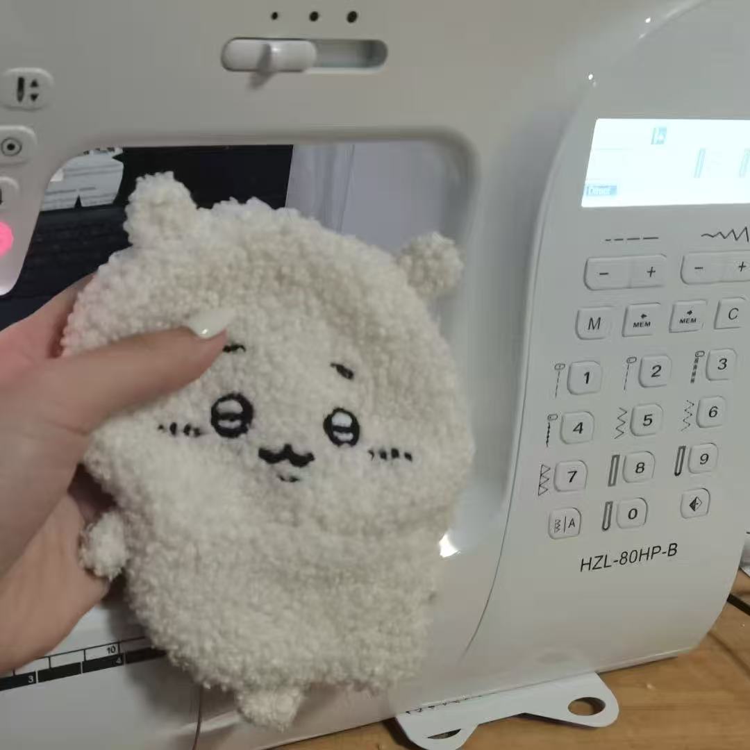 A handmade plush sewing project beside a sewing machine